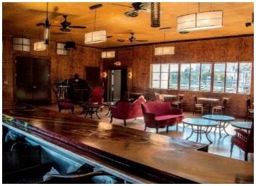 After: view of the second floor lounge with refinished original plywood paneled walls